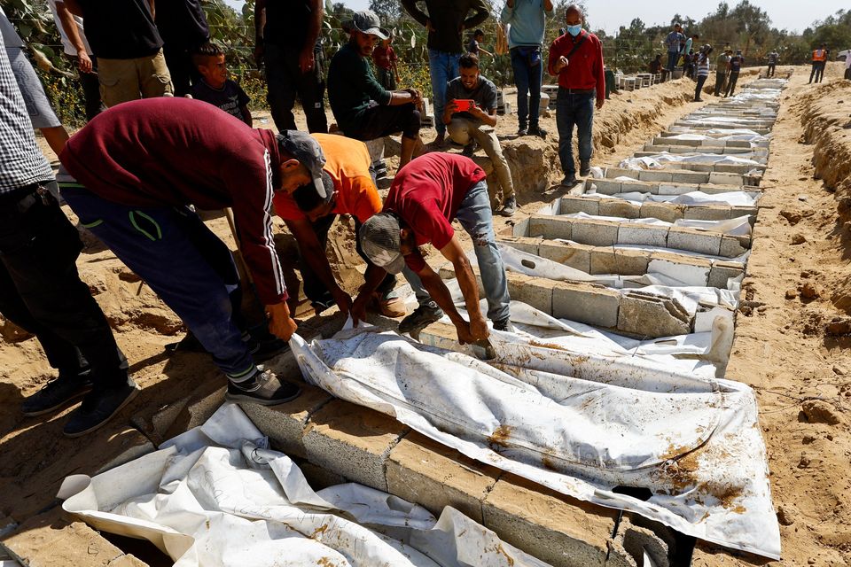 People bury unidentified bodies of Palestinians who had been held in Israel during the war, after they were handed over by Israel in Gaza, in Deir Al-Balah, in the central Gaza Strip, yesterday. Photo: Reuters